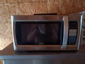 lot 41 image: Used Oster Microwave Oven with Digital Controls