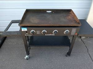 lot 57 image: Used Blackstone Outdoor Griddle with 4 Burners on Wheels