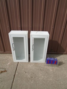 Qty of 2 glass door cabinets. 1 with wheel lock & key. As shown.