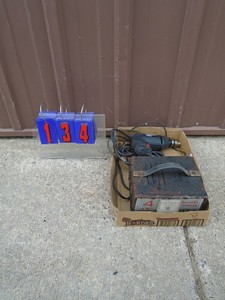 lot 134 image: 4 amp battery charger & 110 volt drill. As shown.