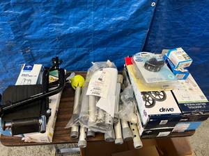 lot 43 image: Huge Lot of NEW Wheelchair Walker Replacement Support Wheels and Foot Rests Attachments & More