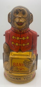 lot 67 image: Vintage J. Chein & Co Tin Monkey Bank and Schuco Wind-Up Car Toy