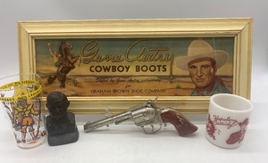 lot 71 image: Gene Autry Cowboy Boots Sign with Vintage Davy Crockett Glass, Hopalong Cassidy Mug, and Toy Gun