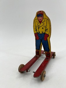lot 187 image: Vintage Wolverine Tin Skier Toy
