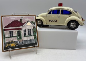 lot 323 image: Vintage Toy Police Car with New Zealand House Tile Art