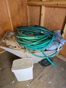 lot 90 image: Plastic Rubbermaid Garden Cart with Burlap, Garden Hoses and Other Things