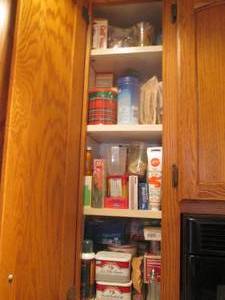 lot 110 image: Cupboard filled with cake and kitch...