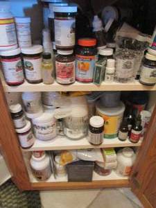 lot 141 image: Cupboard filled with supplements an...