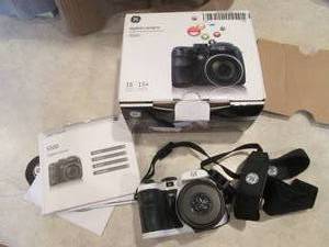 lot 166 image: GE digital camera with papers in or...