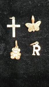 lot 13 image: Four 14K Gold Charms