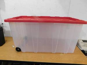 lot 156 image: HDX 77 Gal. Tough Storage Tote with Wheels in Clear with Red Lid