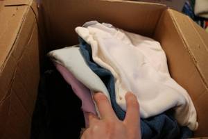 lot 514 image: small box of clothes and fabric see...