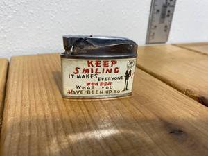 lot 20-B2025 image: Vintage Empire Novelty Funny Cartoon Lighter Keep Smiling  It Makes Everyone Wonder What You Are Up To.