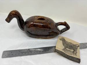 lot 45-B2025 image: Antique Employee Trail Item from Bennington Pottery (based on the door design on back) Brown Dip Glaze Duck Gravy Boat