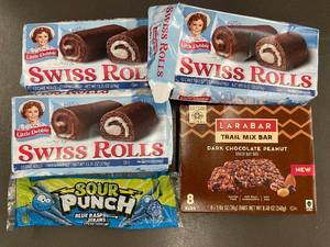 lot 116 image: Assorted Snack Set Swiss Rolls, Sour Punch Straws, LRABAR Trail Mix