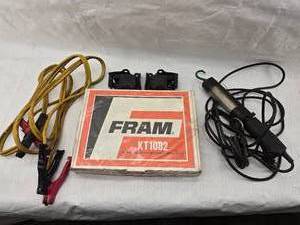 lot 130 image: Fram Transmission Overhaul Kit, Jumper Cables, Shop Light and GM Motor Mounts