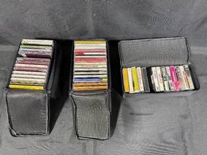 lot 303 image: Collection of Music Cassettes and CDs in Case Logic Cases