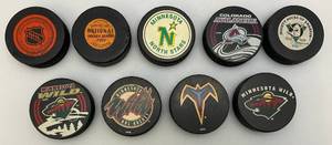 lot 188 image: Misc. Team Hockey Pucks & More