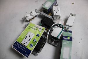 lot 381 image: Assortment of Leviton Electrical Outlets and Switches