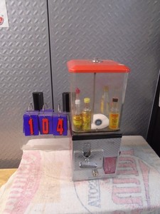 25 cent candy machine with fake contents. No key. As shown.