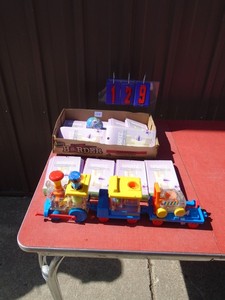 lot 129 image: Flat of Easter egg decorations, fixtures & play school train. As shown.
