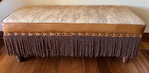 lot 20 image: Rustic Faux Cowhide and Pleather Bench with Fringe Detailing