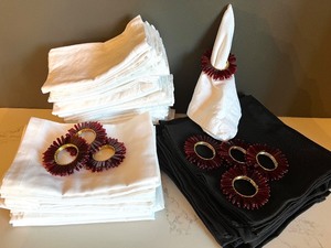 lot 46 image: Over 40 Black and White Cloth Napkins with 8 Red Beaded Napkin Rings