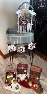 lot 202 image: Christmas Decor Set Stockings, Rustic Metal Display and Decorated Small Sled DoorWall Decor