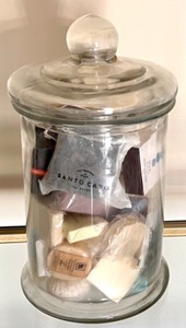 lot 304 image: Glass Jar Filled with Assorted Scented Soaps and Bath Accessories