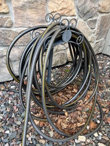 lot 453 image: Garden Hose with Nozzle and Stand, Shepherd Hook with Hummingbird Feeder