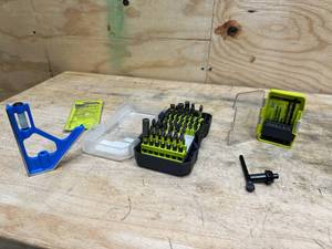 lot 144 image: RYOBI Bundle. 40 piece impact drill set, Drills On Contact attachments, chuck key, 58 in. Black Metal Chuck Key with 516 in. Pilot, Leveler