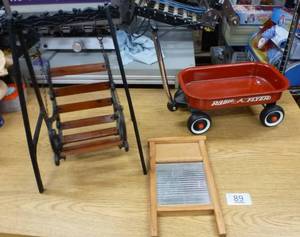 lot 89 image: Doll Radio Flyer, its about 18 inches long plus the handle, cast iron and wood doll swing and small washboard