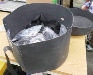 lot 124 image: 30 guitar straps, 5 amp plugs with straps, some also have picks, all in an old cardboard drum carrying box