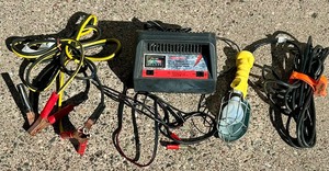 lot 144A image: Mechanics Helpers  Including Schumacher Electric Manual Battery Charger, Jumper Cables and Shop Light