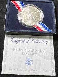 lot 112 image: 1991 USO 50TH ANNIVERSARY COMMEM SILVER DOLLAR