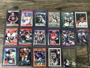 lot 383 image: Lot of 17 Football and Baseball Cards - Joe Montana - Cal Ripken Jr. - Steve Young and More