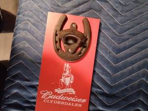lot 204 image: Vintage Budweiser bottle opener mounted on a Budweiser board