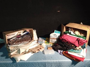 lot 174 image: 2 Boxes, smoke free material, and a bag of womens clothes patterns, sewing idea books and more
