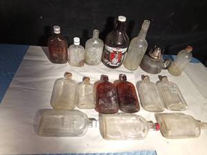 lot 355 image: Vintage bottles and a growler and a lantern base