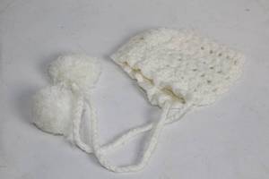 lot 75 image: Handcrafted White Crochet Baby Bonnet with Pompoms