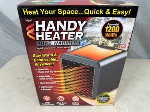 lot 67 image: New Handy Heater Pure Warmth Ceramic Space Heater with LED Lights
