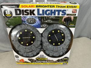 lot 82 image: New 4 Pack of Solar Powered LED Disk Landscaping Lights