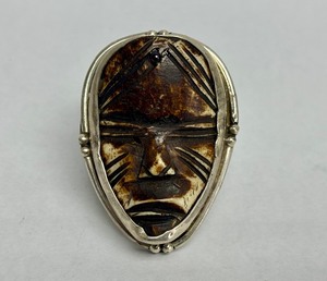 lot 23 image: Vintage Carved Bone & Sterling Silver Face Pendant