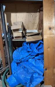lot 244 image: Construction Nails, Screws, and Coil Nails Collection with Blue Tarp