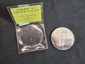 lot 23 image: 2006 American Silver Eagle Coin with Protective Sleeve
