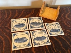 lot 54 image: Five Blue and White Holland America Line Coasters with Wooden Holder