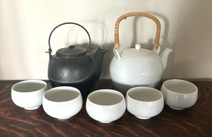 lot 195 image: Two Teapots with Teacups including a Cast Iron Tea Kettle