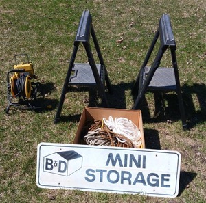 lot 2 image: Pair of Plastic Sawhorses, Rope, Shop Light, Metal Sign