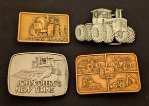 lot 123 image: Four Vintage John Deere Belt Buckles