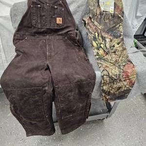 lot 251 image: Carthartt Brown Duck Bibs-38x30 and Camo Pants 36x32, like new condition with Tags